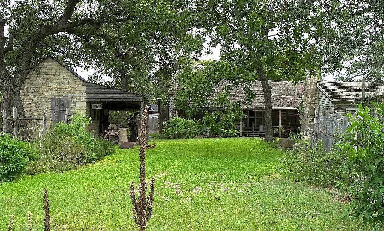 Moore-Hancock Farmstead stone and log buildings under mature trees